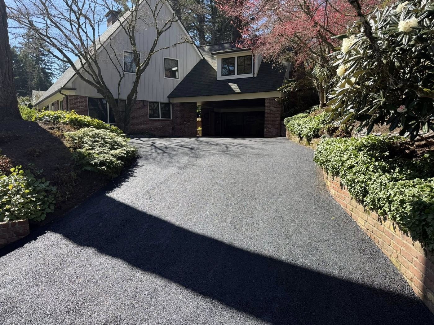 Beautiful freshly sealed residential driveway with spring landscaping in Columbus, Ohio